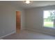 Neutral bedroom features a closet and bright window at 54 Cultivator Ct, Angier, NC 27501