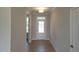 Bright entryway with hardwood flooring leading to a glass-paneled front door at 54 Cultivator Ct, Angier, NC 27501