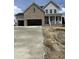 New two-story home with a two-car garage, brick accents, and a charming front porch at 54 Cultivator Ct, Angier, NC 27501