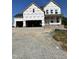 New two-story home under construction with a large garage and front porch, awaiting finishing touches at 54 Cultivator Ct, Angier, NC 27501