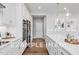Modern kitchen with white cabinets, stainless steel appliances, and hardwood floors at 54 Cultivator Ct, Angier, NC 27501