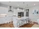Modern kitchen with white cabinets and island at 54 Cultivator Ct, Angier, NC 27501