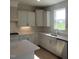 Bright kitchen featuring white cabinets, stainless steel appliances, and stylish backsplash at 54 Cultivator Ct, Angier, NC 27501