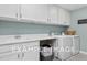Laundry room with white cabinets and washer and dryer at 54 Cultivator Ct, Angier, NC 27501