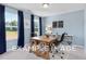 Home office featuring a wooden desk, two chairs, and large windows at 54 Cultivator Ct, Angier, NC 27501