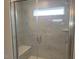 Walk-in shower featuring white marble tile and bench at 54 Cultivator Ct, Angier, NC 27501