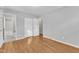 Bedroom with hardwood floors, neutral walls, two closets, and access to bathroom at 704 Sunnybrook Rd, Raleigh, NC 27610