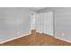 Empty bedroom with hardwood floors, large closets and neutral walls at 704 Sunnybrook Rd, Raleigh, NC 27610