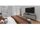 Relaxing bedroom featuring stylish furniture and an open bathroom at 704 Sunnybrook Rd, Raleigh, NC 27610