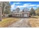 Ranch home with a gray exterior, and a paved driveway at 704 Sunnybrook Rd, Raleigh, NC 27610
