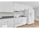 White kitchen with modern appliances and ample cabinet space at 704 Sunnybrook Rd, Raleigh, NC 27610