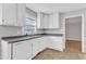 Kitchen featuring a double basin sink, white cabinets, ample counter space and vinyl floors at 704 Sunnybrook Rd, Raleigh, NC 27610