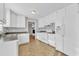 Bright kitchen featuring white cabinetry, an electric range, and a refrigerator with water dispenser at 704 Sunnybrook Rd, Raleigh, NC 27610