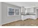 Bright kitchen featuring a large window, white cabinetry and plenty of room to expand at 704 Sunnybrook Rd, Raleigh, NC 27610