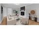 Virtually staged living room with fireplace, modern decor and hardwood floors at 704 Sunnybrook Rd, Raleigh, NC 27610