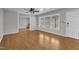 Open living room with hardwood floors, large windows, and ample natural light at 704 Sunnybrook Rd, Raleigh, NC 27610