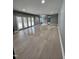 Spacious basement with light hardwood floors and doors leading to the backyard at 72 Beverly Dr, Durham, NC 27707