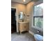 Modern bathroom with wood vanity, marble countertop and herringbone floor at 72 Beverly Dr, Durham, NC 27707