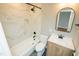 Modern bathroom featuring a tiled shower, wood vanity, and neutral color palette at 72 Beverly Dr, Durham, NC 27707