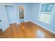 Bedroom boasts hardwood floors and a window with natural light; leading to the bathroom at 72 Beverly Dr, Durham, NC 27707