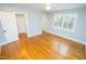 Bright bedroom with hardwood floors, ceiling fan, and neutral walls with a double window at 72 Beverly Dr, Durham, NC 27707