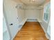 Spacious walk-in closet featuring custom shelving, hardwood floors, and natural light at 72 Beverly Dr, Durham, NC 27707