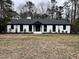 White brick ranch house with black accents, landscaped yard at 72 Beverly Dr, Durham, NC 27707