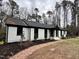 White brick ranch house with black accents, brick walkway at 72 Beverly Dr, Durham, NC 27707