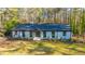 Beautifully landscaped home with brick and black trim with a lush green yard at 72 Beverly Dr, Durham, NC 27707