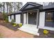 A beautifully designed front porch with black trim and fresh landscaping at 72 Beverly Dr, Durham, NC 27707