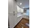 Renovated kitchen, featuring white shaker cabinets, quartz countertops and hardwood floors at 72 Beverly Dr, Durham, NC 27707