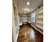 Spacious walk-in closet with built-in shelving and hardwood floors at 72 Beverly Dr, Durham, NC 27707