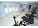 Bright workout room with exercise equipment, walkout access to backyard and pool and wall art at 72 Beverly Dr, Durham, NC 27707