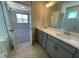 Bathroom featuring dual sinks, and a large mirror with a view into the primary bedroom at 82 N Stagecoach Dr, Wendell, NC 27591