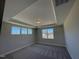 Spacious bedroom featuring three windows, a modern ceiling fan, and plush carpeting at 82 N Stagecoach Dr, Wendell, NC 27591