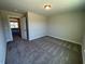 Bedroom featuring carpeted floors, white trim, and a doorway to the adjacent room at 82 N Stagecoach Dr, Wendell, NC 27591