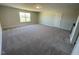 Large bonus room with plush carpet, a window, and a doorway to the landing area at 82 N Stagecoach Dr, Wendell, NC 27591