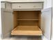 Open gray cabinet with wood shelving and a pull-out drawer, offering ample storage space at 82 N Stagecoach Dr, Wendell, NC 27591