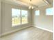 Bright dining room with large windows overlooking a lawn and adjacent wooden deck at 82 N Stagecoach Dr, Wendell, NC 27591