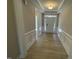 Bright foyer with wood-look tile flooring, wainscoting, and a view of the front door at 82 N Stagecoach Dr, Wendell, NC 27591