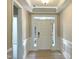 Bright foyer featuring a stylish front door with sidelights and classic wainscoting for an elegant touch at 82 N Stagecoach Dr, Wendell, NC 27591