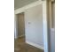 Neutral hallway with wooden floors leading into other rooms and neutral colored walls at 82 N Stagecoach Dr, Wendell, NC 27591