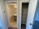 This hallway leads to the bathroom and pantry, featuring neutral walls and carpet floors at 82 N Stagecoach Dr, Wendell, NC 27591