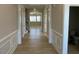 View of a well-lit hallway with decorative trim, wood floors, and an open floor plan at 82 N Stagecoach Dr, Wendell, NC 27591