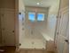 Modern glass shower with built-in seat, white tile, and window at 82 N Stagecoach Dr, Wendell, NC 27591