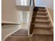 Carpeted stairway with wood handrails at 82 N Stagecoach Dr, Wendell, NC 27591
