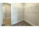 A bright walk-in closet offers shelving and an opening to another room with tile flooring at 82 N Stagecoach Dr, Wendell, NC 27591