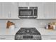 Stainless steel range and microwave above in a modern kitchen setting at 8947 Kennebec Crossing Dr # 53, Angier, NC 27501