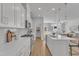 Open concept kitchen with white cabinets, an island, and access to backyard at 8947 Kennebec Crossing Dr # 53, Angier, NC 27501