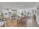Open concept kitchen with island, white cabinets, and hardwood floors at 8947 Kennebec Crossing Dr # 53, Angier, NC 27501